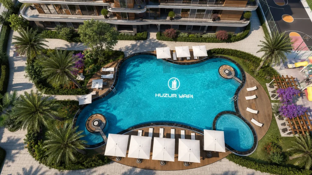 Serbest formlu yüzme havuzu, güneşlenme terasları, çocuk oyun alanı, basketbol sahası ve peyzaj bulunan konut sitesi