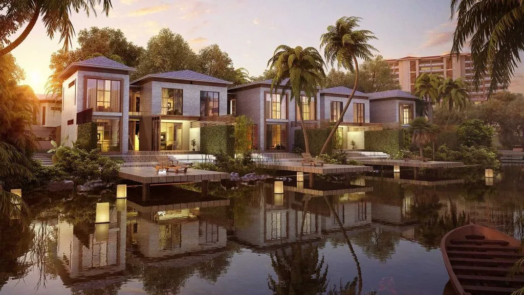 Göl kenarında konumlanan, taş cepheli, geniş cam yüzeyli ve tropikal peyzajla çevrili modern villa sitesi